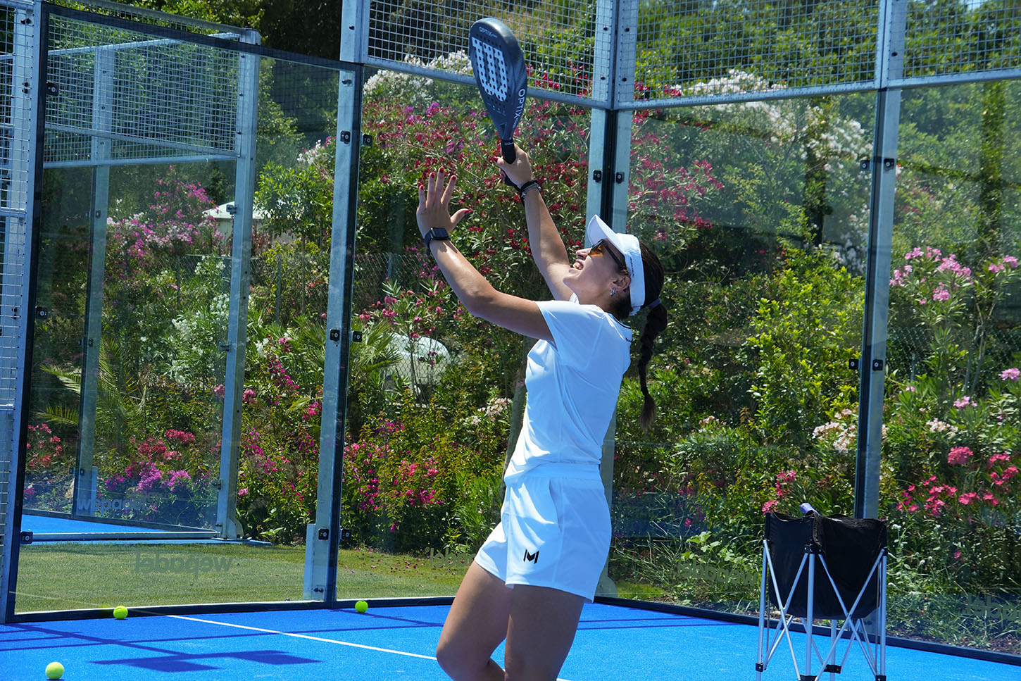 Player practicing an overhead shot during a padel training session at M Padel Bodrum.